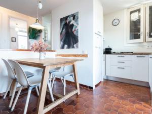 a kitchen and dining room with a wooden table and chairs at Apartment Ursula by Interhome in Torredembarra