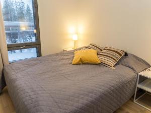 a bedroom with a bed with two pillows and a window at Holiday Home Ylälänsi 3 as 5 by Interhome in Ylläsjärvi