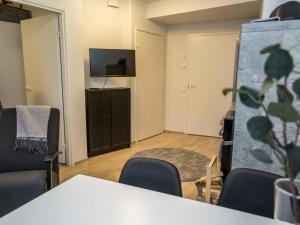 a room with a table and chairs and a flat screen tv at Holiday Home Ylälänsi 3 as 5 by Interhome in Ylläsjärvi