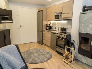 a kitchen with stainless steel appliances and a living room at Holiday Home Ylälänsi 3 as 5 by Interhome in Ylläsjärvi