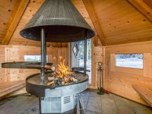 an outdoor oven in a cabin with wooden walls at Holiday Home Kielo by Interhome in Pertunmaa +25 photos
