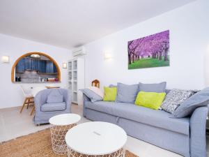 - un salon avec un canapé bleu et une table dans l'établissement Apartment Pueblo Panorama-1 by Interhome, à Benitachell