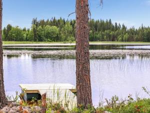 a boat sitting in the middle of a lake at Holiday Home Kielo by Interhome in Pertunmaa