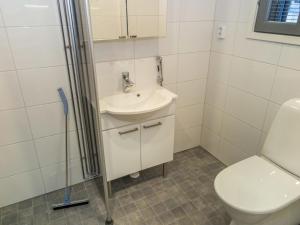 a bathroom with a toilet and a sink and a shower at Holiday Home Ylälänsi 3 as 5 by Interhome in Ylläsjärvi +5 photos