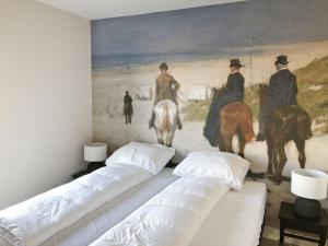 a room with three beds and a painting on the wall at Holiday Home Oesterdam Resort-1 by Interhome in Tholen +12 photos