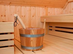 a wooden bucket in the inside of a sauna at Holiday Home Bungalowpark It Wiid by Interhome in Eernewoude