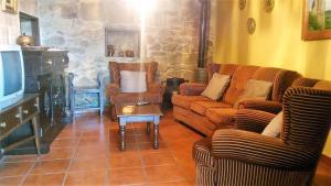 a living room with two couches and a tv at Casa de pueblo en Galicia, A Forneira in Leiro