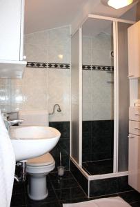 a bathroom with a sink and a toilet and a shower at Apartments Lokunja in Pag +19 photos