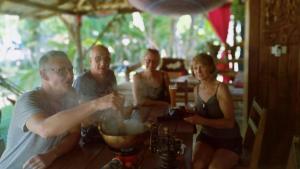 a group of people sitting at a table at Ko Yao Noi Sabai Bungalows in Ko Yao Noi