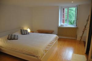 a bedroom with a white bed and a window at s'YVOUX plaît in La Chapelle