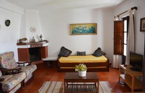 a living room with a couch and a bed at Apartamentos Cintra do Vale in Vila Nova de Milfontes