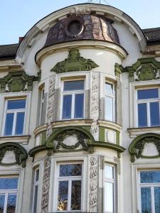 a tall building with windows and a dome at Apartament na Granicy / Apartment on the border in Cieszyn