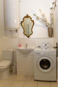 a bathroom with a washing machine and a sink at L'ambassadeur - Colmar centre in Colmar +67 photos