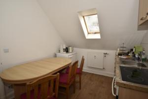 a small kitchen with a wooden table and a sink at Ferienwohnung Villa Weyermann in Leichlingen