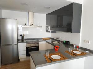 Kuchyň nebo kuchyňský kout v ubytování Apartamento Cruise Views