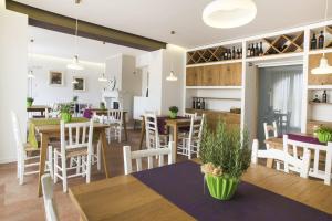 a dining room and kitchen with tables and chairs at Agriturismo Canova in Negrar