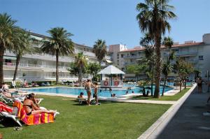 a group of people sitting on lawn chairs near a swimming pool at ILLA MAR DOR 146 in L'Estartit