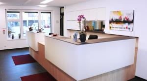 a large kitchen with a counter with flowers on it at Europa-Haus-Bocholt - Bett & Bike in Bocholt