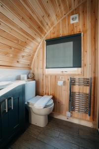 a wooden bathroom with a toilet and a window at North Coast 500 Pods in Achmelvich