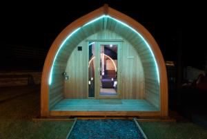 a small igloo house with a door in the night at North Coast 500 Pods in Achmelvich