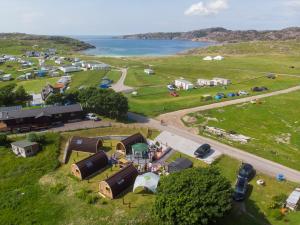 an aerial view of a camp site with a road and a lake at North Coast 500 Pods in Achmelvich