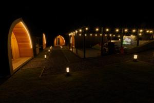 a row of lights in a courtyard at night at North Coast 500 Pods in Achmelvich