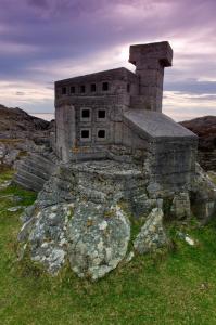 a stone building sitting on top of a rock at North Coast 500 Pods in Achmelvich
