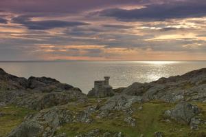 a building on the rocks near the water at North Coast 500 Pods in Achmelvich