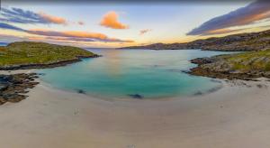 an aerial view of a beach at sunset at North Coast 500 Pods in Achmelvich