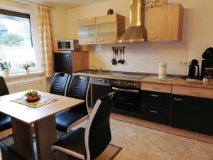 a kitchen with a table and a stove top oven at Ferienwohnung Einenkel in Seiffen