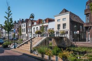 a row of houses and stairs in a city at Apple Tree Cottage - charming home at beautiful canal in our idyllic garden in Gouda