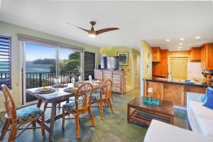 a kitchen and living room with a table and chairs at Kepuhi Hale TVNC #5156 in Hanalei