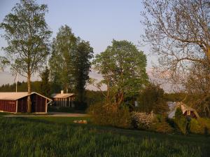 a house in the middle of a field with trees at Pohlametsa Holiday House in Nüpli