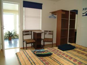 1 dormitorio con 2 camas, mesa y sillas en Pohlametsa Holiday House, en Nüpli