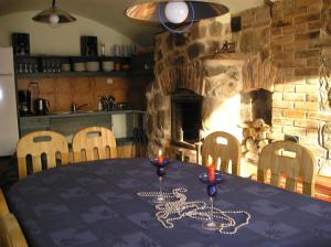 a table in a kitchen with a fireplace at Pohlametsa Holiday House in Nüpli