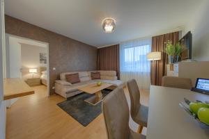 a living room with a couch and a table at Best Western Hotel Wetzlar in Wetzlar