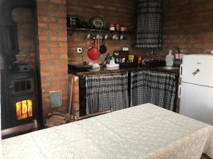a kitchen with a stove and a white refrigerator at Zlatibor Cottages in Zlatibor