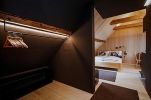 a bedroom with a bed in a room with black walls at JH4 Stadthaus mit 4 Wohnungen im Jüdischen Viertel in Hohenems