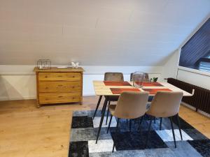 a dining room with a table with chairs and a dresser at Ferienwohnung Steiner 2 in Homburg