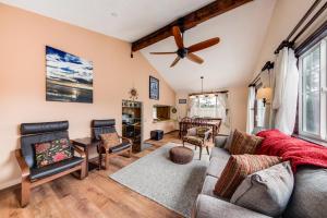 a living room with a couch and a ceiling fan at Shore Pine Hideaway in Lincoln City