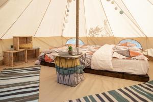 a bedroom with a bed in a tent at Dragonfly Gardens Urban Glamping Brasov in Braşov