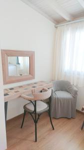 a bedroom with a desk and a chair and a mirror at Lefkada Princess Junior Suite in Lefkada Town