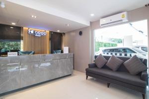 a living room with a couch in front of a store at So good Hotel Bangkok in Bangkok