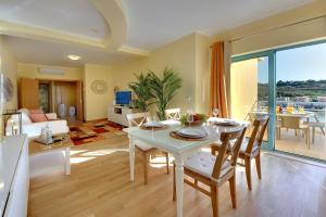 a kitchen and living room with a table and chairs at Marina Ocean Residence in Albufeira