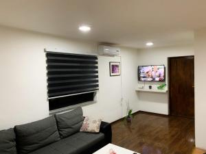 a living room with a couch and a flat screen tv at Modern Apartment in Brčko