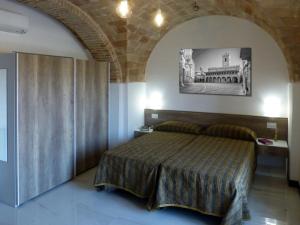 a bedroom with a bed in a room at Residence Borgo Offida in Offida