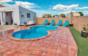 a patio with chairs and a swimming pool at Casetes Joan de Pataca 5 in Deltebre