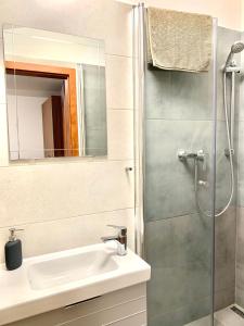 a bathroom with a sink and a shower at Pohoda Ubytovanie Stupava in Stupava