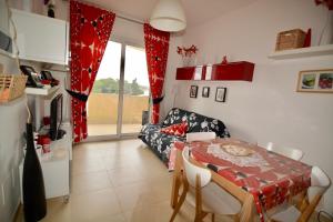 a living room with a table and a couch at Terrazza Merope in Torre dell'Orso