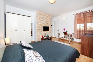 a bedroom with a large bed and a table with a desk at F&R Apartments in Rovinj